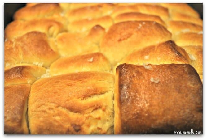 These Parker House rolls are simply decadent. According to Wikipedia, Parker House rolls were invented at the Parker House Hotel in Boston during the 1870's, most likely created by an angry cook throwing unfinished rolls into the oven which resulted in their dented appearance.