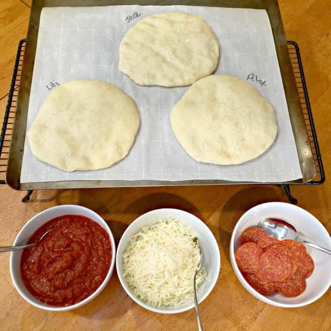 When I have the time, I love making pizza at home vs. ordering out for delivery. Especially when I can get my kids involved in make your own mini pizzas for dinner! The pizza dough comes together quickly and doesn't require time to rise, so you don't need to remember to start in advance (bonus!). And since this recipe makes enough for 12 mini pizzas- it's perfect for play dates or birthday parties too!