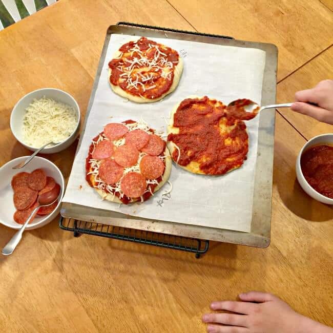 When I have the time, I love making pizza at home vs. ordering out for delivery. Especially when I can get my kids involved in make your own mini pizzas for dinner! The pizza dough comes together quickly and doesn't require time to rise, so you don't need to remember to start in advance (bonus!). And since this recipe makes enough for 12 mini pizzas- it's perfect for play dates or birthday parties too!