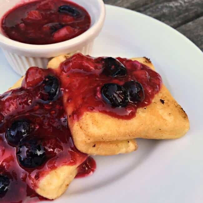 My family LOVES these creamy yet crispy homemade cheese blintzes with a berry compote topping. It's one of those special occasion dishes that will become a family tradition!